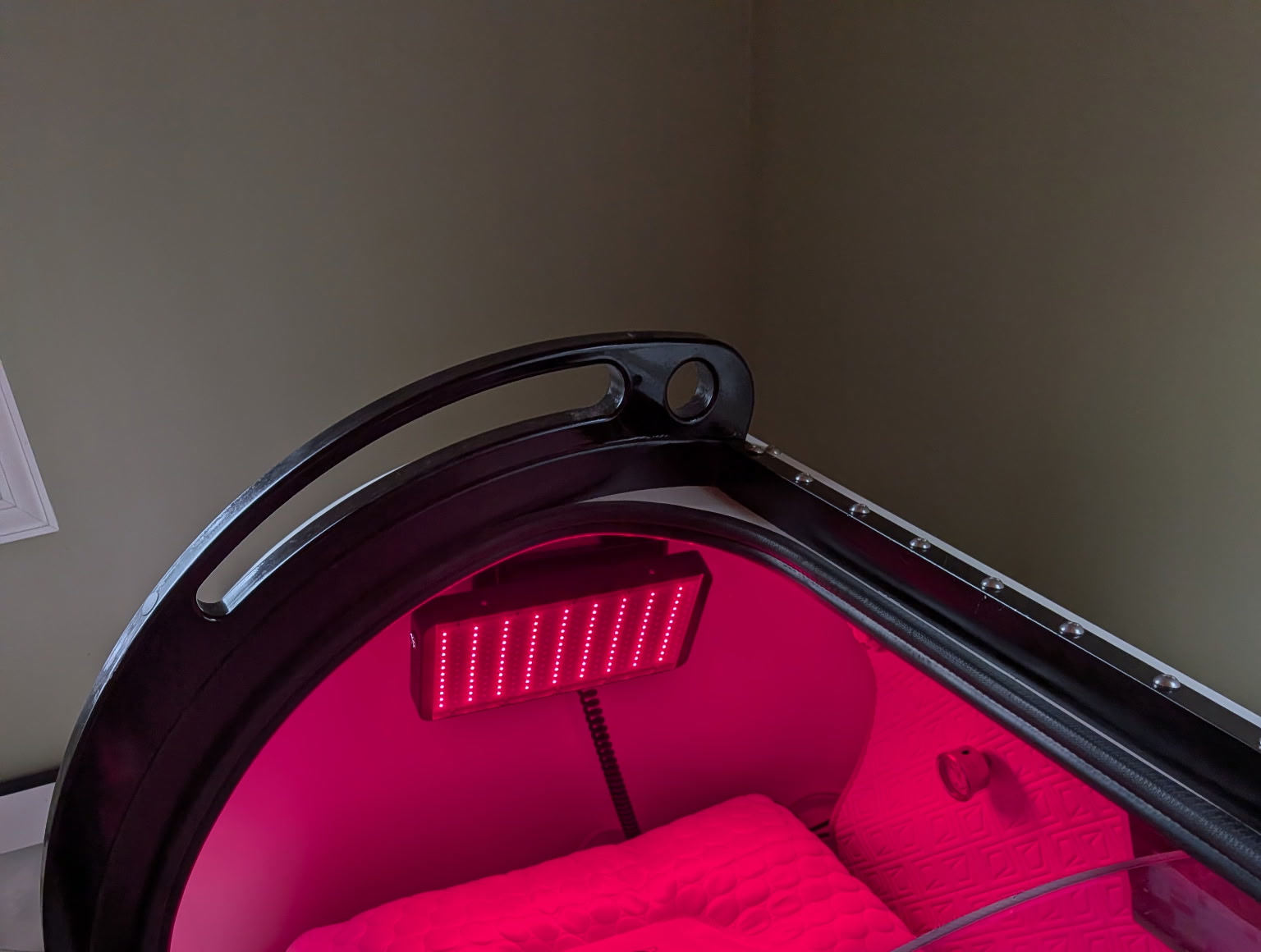 Real installation photo showing the chamber opening, interior, and mounted red-light panel
