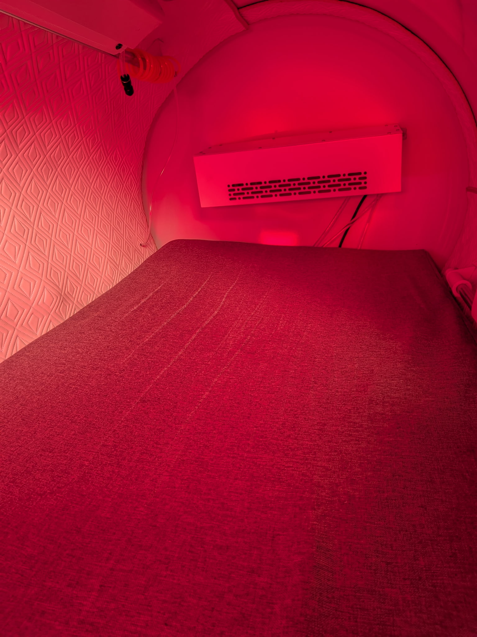 A hardshell chamber interior with a padded surface and installed red-light fixture