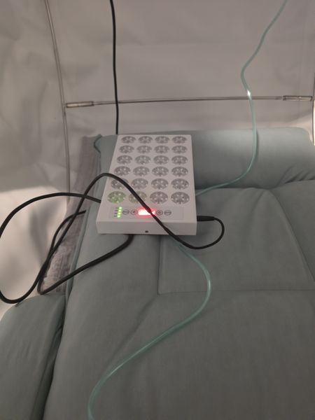 Panel resting on the chamber mattress, cable routed to power
